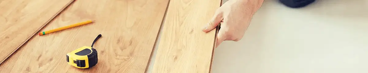 A professional installing wood flooring in Hollywood, FL