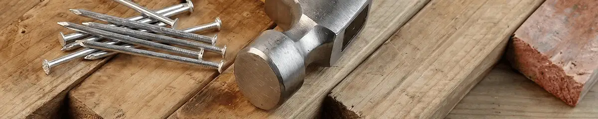 Hammer and nails on hardwood flooring boards in Hollywood, FL