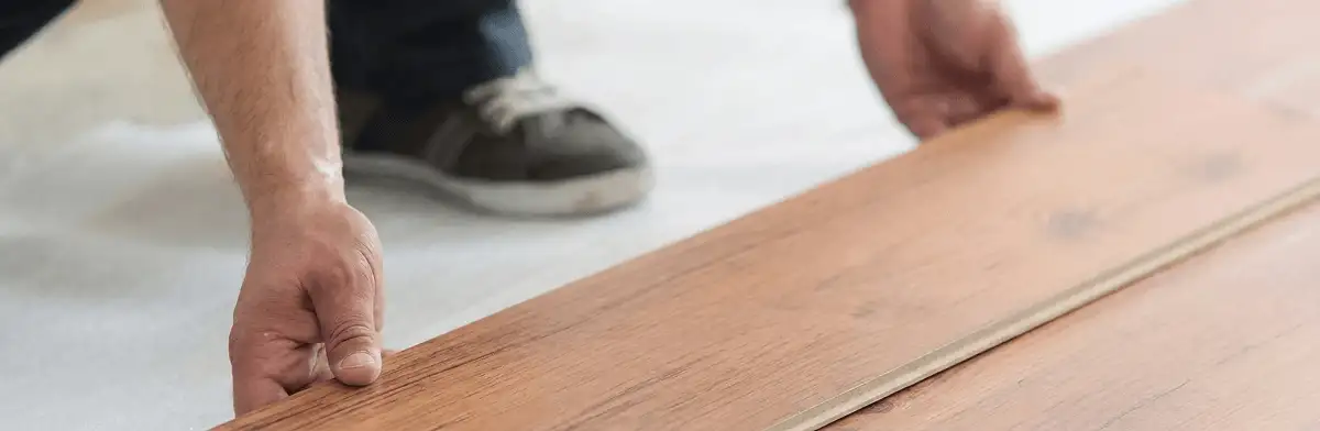 A professional installing laminate flooring in Hollywood, FL